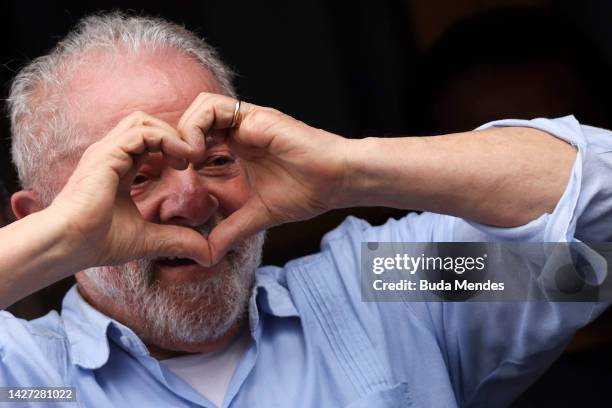 Brazil's former president and current presidential candidate Luiz Inacio Lula da Silva greets to supporters during a campaign rally in the final week...