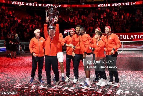 John McEnroe, Captain of Team World celebrates with the Laver Cup trophy alongside Team World teammates during Day Three of the Laver Cup at The O2...