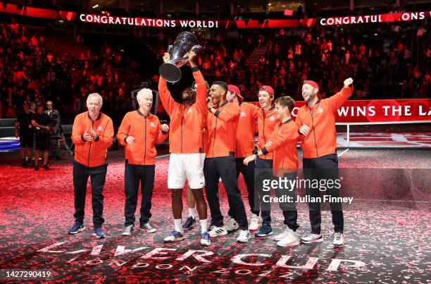 Frances Tiafoe of Team World celebrates with the Laver Cup trophy alongside Team World teammates during Day Three of the Laver Cup at The O2 Arena on...