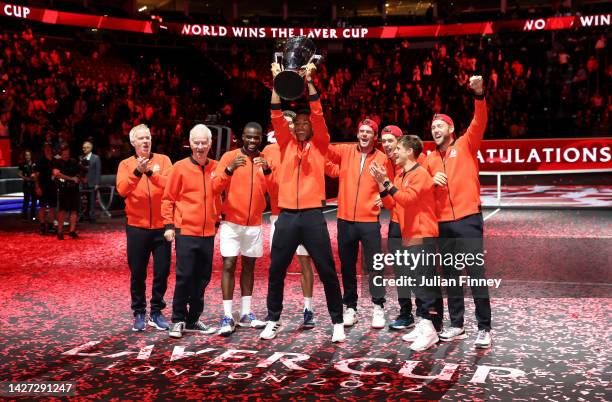 Felix Auger-Aliassime of Team World celebrates with the Laver Cup trophy alongside Team World teammates during Day Three of the Laver Cup at The O2...