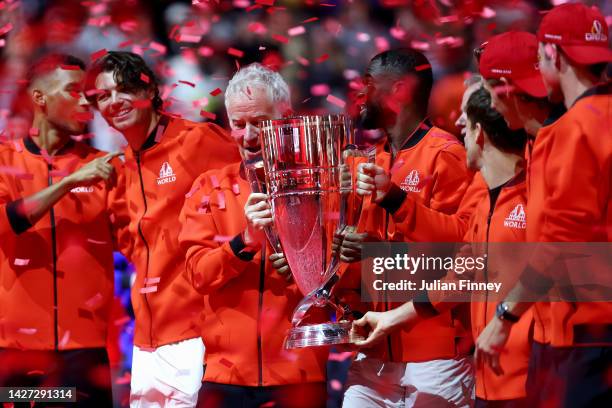 John McEnroe, Captain of Team World and Frances Tiafoe of Team World celebrate with the Laver Cup trophy during Day Three of the Laver Cup at The O2...