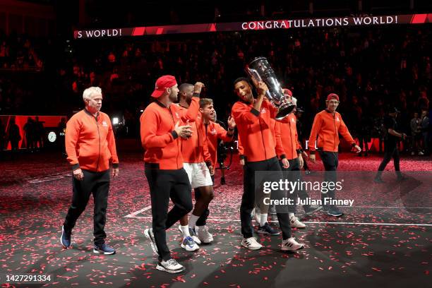 Felix Auger-Aliassime of Team World celebrates with the Laver Cup trophy alongside Team World teammates during Day Three of the Laver Cup at The O2...