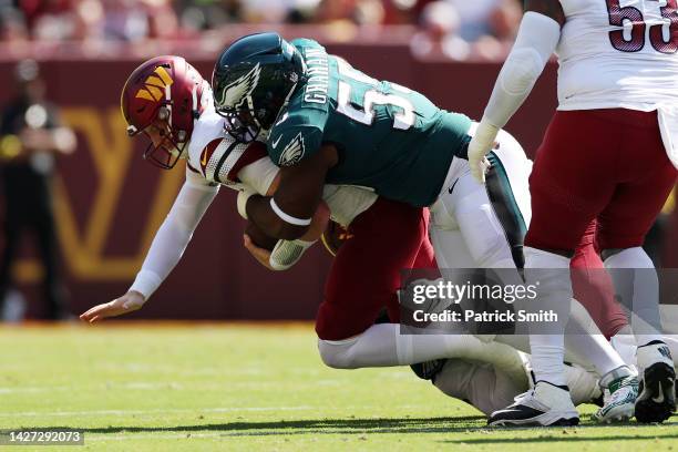 Defensive end Brandon Graham of the Philadelphia Eagles sacks quarterback Carson Wentz of the Washington Commanders during the first half at...