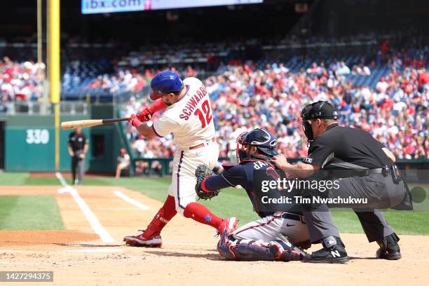 Kyle Schwarber of the Philadelphia Phillies hits a solo home run during the first inning against the Atlanta Braves at Citizens Bank Park on...