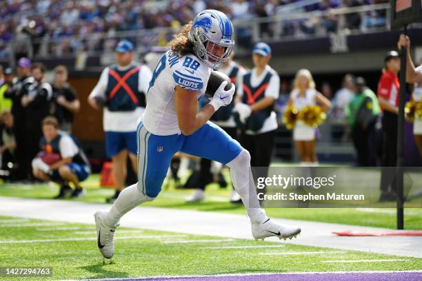 Tight end T.J. Hockenson of the Detroit Lions scores on a pass reception in the second quarter of the game against the Minnesota Vikings at U.S. Bank...