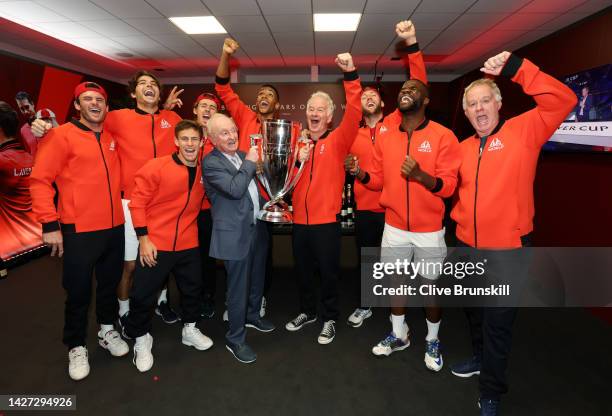 Players of Team World celebrate with the Laver Cup trophy alongside Rod Laver in the locker room during Day Three of the Laver Cup at The O2 Arena on...