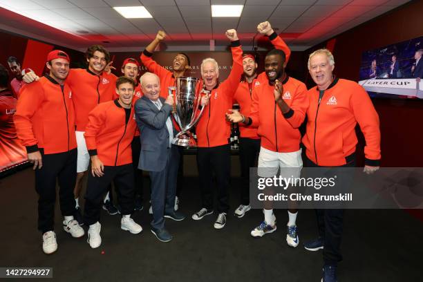 Players of Team World celebrate with the Laver Cup trophy alongside Rod Laver in the locker room during Day Three of the Laver Cup at The O2 Arena on...