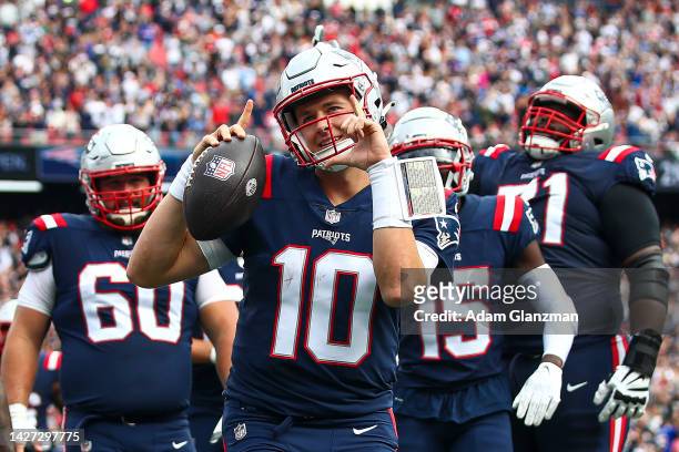 Quarterback Mac Jones of the New England Patriots celebrates after scoring a touchdown during the second quarter at Gillette Stadium on September 25,...