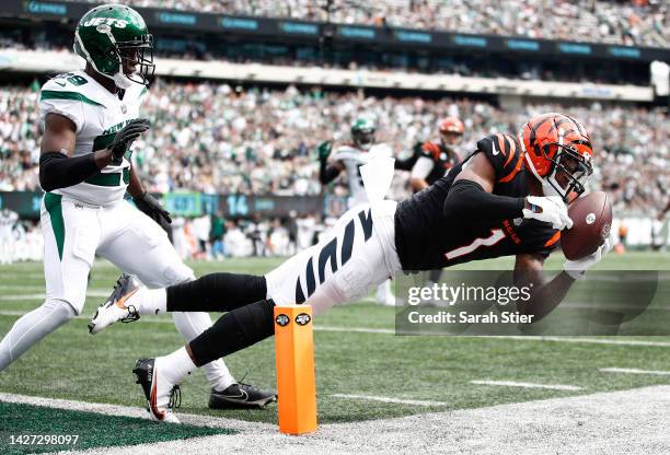 Ja'Marr Chase of the Cincinnati Bengals makes a catch for a gain while defended by Lamarcus Joyner of the New York Jets during the first half at...