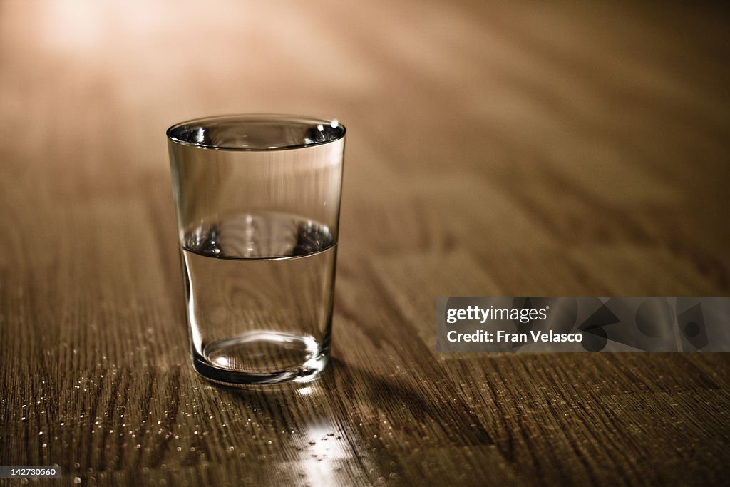 Half-filled glass of water on table