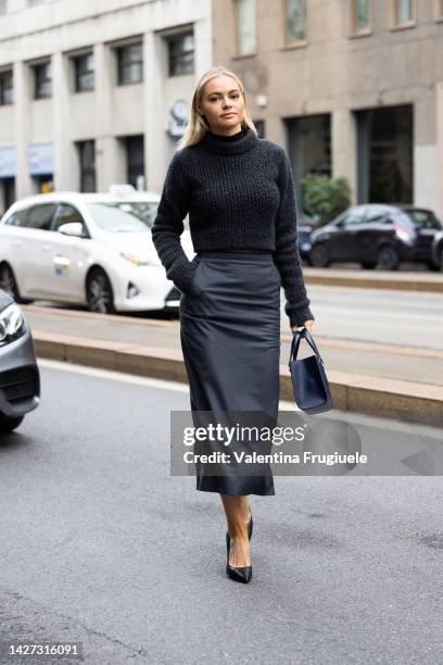 Guest is seen wearing a turtleneck sweater and skirt under the knee at Ferrari show during the Milan Fashion Week - Womenswear Spring/Summer 2023 on...