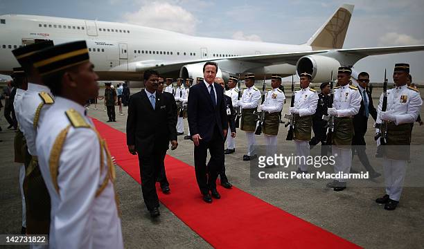 Prime Minister David Cameron walks past a guard of honour on arrival on April 12, 2012 in Kuala Lumpur, Malaysia. Mr Cameron is on a five day visit...