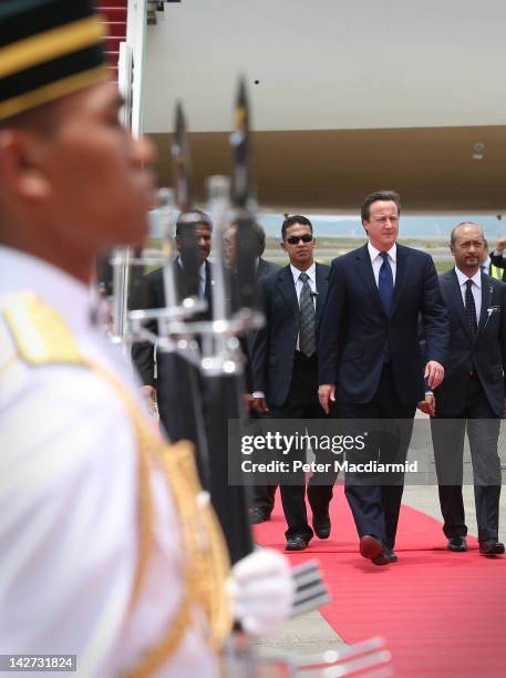 Prime Minister David Cameron walks past a guard of honour on arrival on April 12, 2012 in Kuala Lumpur, Malaysia. Mr Cameron is on a five day visit...