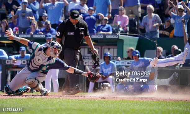 Bobby Witt Jr. #7 of the Kansas City Royals scores against Cal Raleigh of the Seattle Mariners on a Vinnie Pasquantino double in the third inning at...