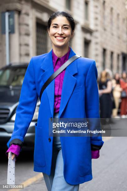 MILAN - JANUARY 13: Woman with Louis Vuitton bag and blue and orange sweater  before Emporio Armani fashion show, Milan Fashion Week street style on Ja  Stock Photo - Alamy