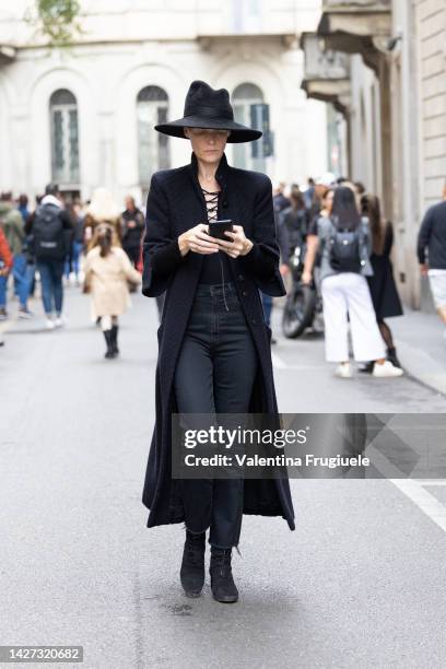 Kate Lanphear is seen wearing a large hat and black coat at Giorgio Armani show during the Milan Fashion Week - Womenswear Spring/Summer 2023 on...