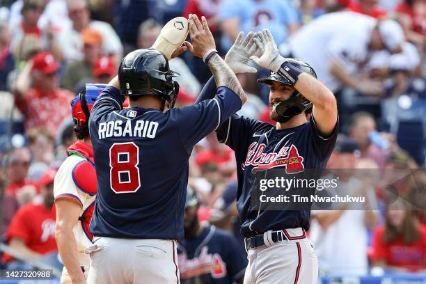 Eddie Rosario and Dansby Swanson of the Atlanta Braves celebrate after scoring during the fourth inning against the Philadelphia Phillies at Citizens...