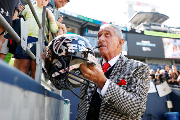Owner Arthur Blank of the Atlanta Falcons signs autographs before the game against the Seattle Seahawks at Lumen Field on September 25, 2022 in...