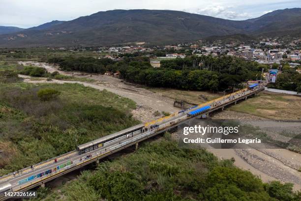 Aerial view of pedestrians crossing the international bridge Simon Bolivar ahead of the commercial border reopening between Venezuela and Colombia on...