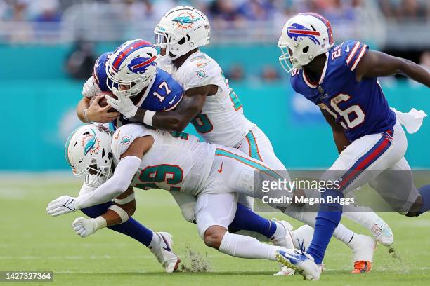 Quarterback Josh Allen of the Buffalo Bills is tackled in the fourth quarter of the game against the Miami Dolphins at Hard Rock Stadium on September...