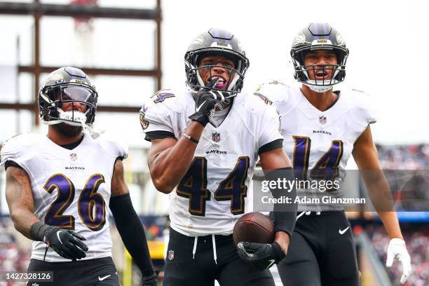 Cornerback Marlon Humphrey of the Baltimore Ravens celebrates with safety Geno Stone of the Baltimore Ravens and safety Kyle Hamilton of the...