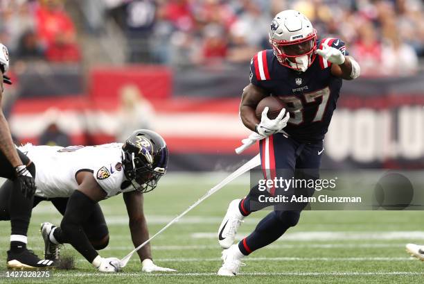 Linebacker Patrick Queen of the Baltimore Ravens attempts to tackle running back Damien Harris of the New England Patriots at Gillette Stadium on...