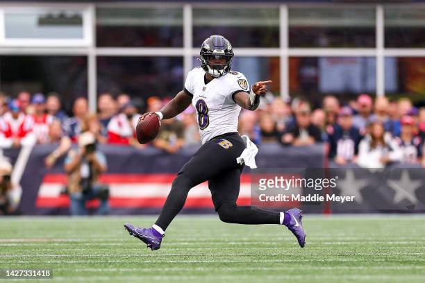 Quarterback Lamar Jackson of the Baltimore Ravens runs the ball during the second half against the New England Patriots at Gillette Stadium on...