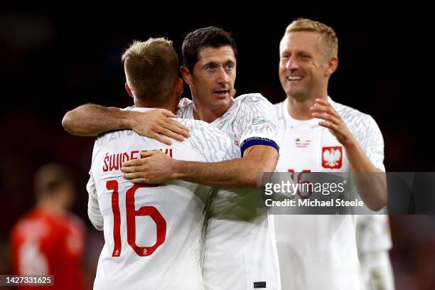 Karol Swiderski of Poland celebrates with teammate Robert Lewandowski after scoring their team's first goal during the UEFA Nations League League A...