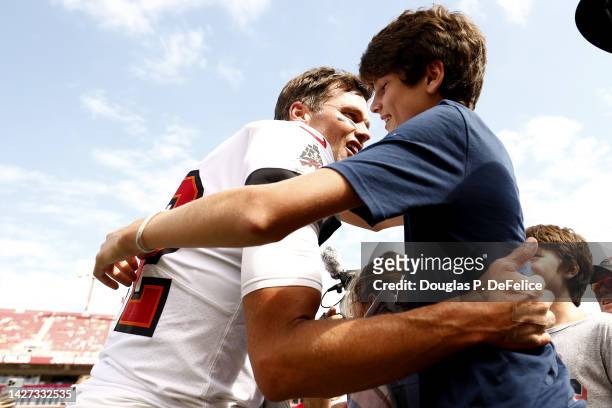Tom Brady of the Tampa Bay Buccaneers hugs his son John Edward Thomas Moynahan on the sidelines prior to the game against the Green Bay Packers at...