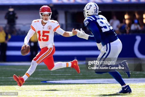 Patrick Mahomes of the Kansas City Chiefs scrambles with the ball as DeForest Buckner of the Indianapolis Colts pursues during the second half at...