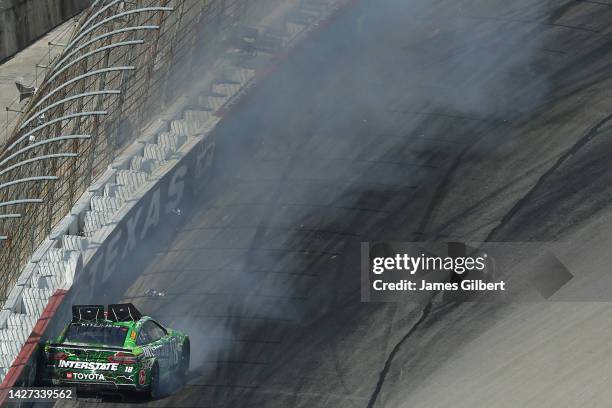 Kyle Busch, driver of the Interstate Batteries Toyota, spins into the wall after an on-track incident during the NASCAR Cup Series Auto Trader...