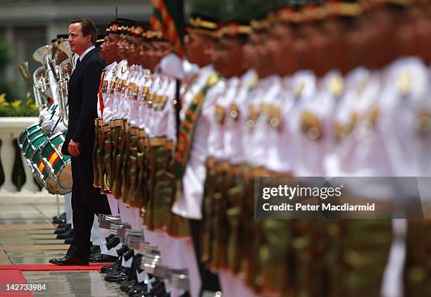 Prime Minister David Cameron walks past a guard of honour at Prime Minister Najib Razak's office on April 12, 2012 in Kuala Lumpur, Malaysia. Mr...