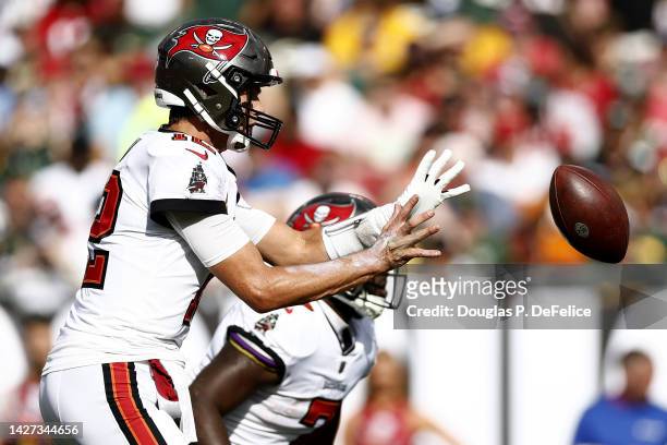 Tom Brady of the Tampa Bay Buccaneers hikes the ball against the Green Bay Packers during the first quarter in the game at Raymond James Stadium on...