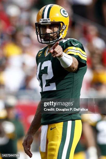 Aaron Rodgers of the Green Bay Packers points against the Tampa Bay Buccaneers during the first quarter in the game at Raymond James Stadium on...