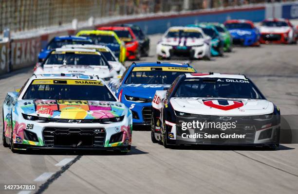 Daniel Suarez, driver of the Aguas Frescas Chevrolet, and Austin Dillon, driver of the True Velocity Chevrolet, race during the NASCAR Cup Series...
