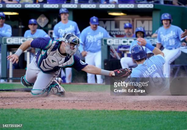 Michael Massey of the Kansas City Royals scores against Cal Raleigh of the Seattle Mariners in the sixth inning at Kauffman Stadium on September 25,...