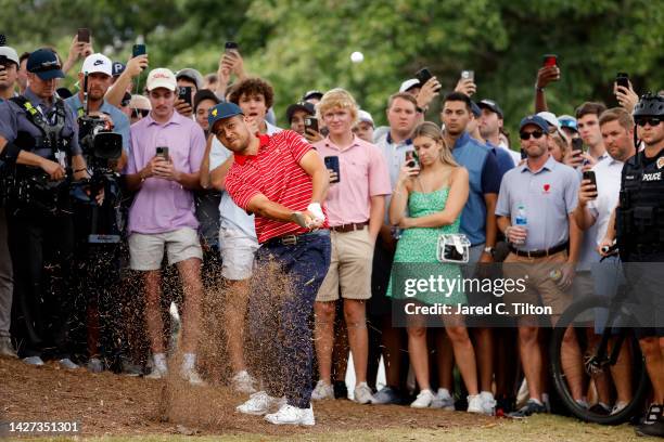 Xander Schauffele of the United States Team plays his third shot on the 17th hole as fans look on during Sunday singles matches on day four of the...