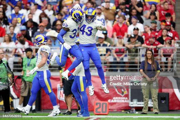 Safety Nick Scott and safety Russ Yeast of the Los Angeles Rams celebrate a partially blocked punt in the first quarter of the game against the...