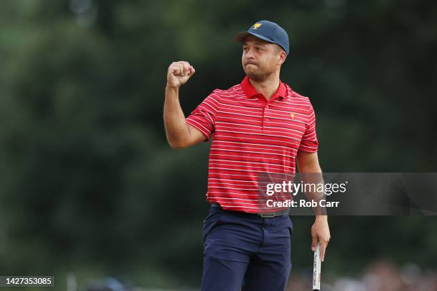 Xander Schauffele of the United States Team celebrates making his putt to win 1 Up against Corey Conners of Canada and the International Team and...