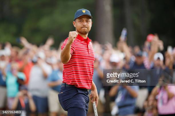Xander Schauffele of the United States Team celebrates making his putt to win 1 Up against Corey Conners of Canada and the International Team and...