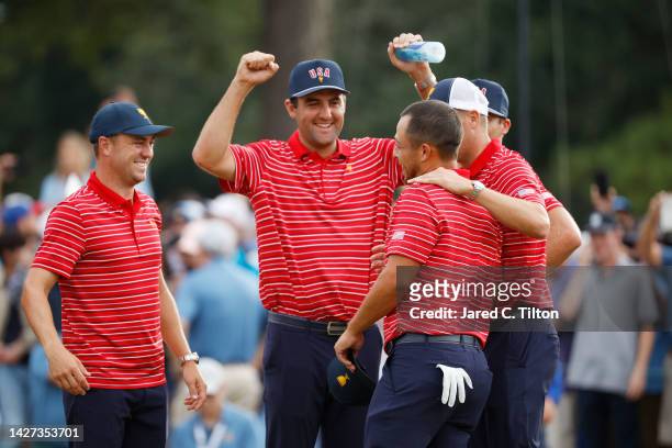 The United States Team congratulate teammate Xander Schauffele after his 1 Up win clinched victory for the team during Sunday singles matches on day...