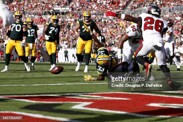 Aaron Jones of the Green Bay Packers fumbles the ball on the goal line recovered by Logan Ryan of the Tampa Bay Buccaneers during the second quarter...