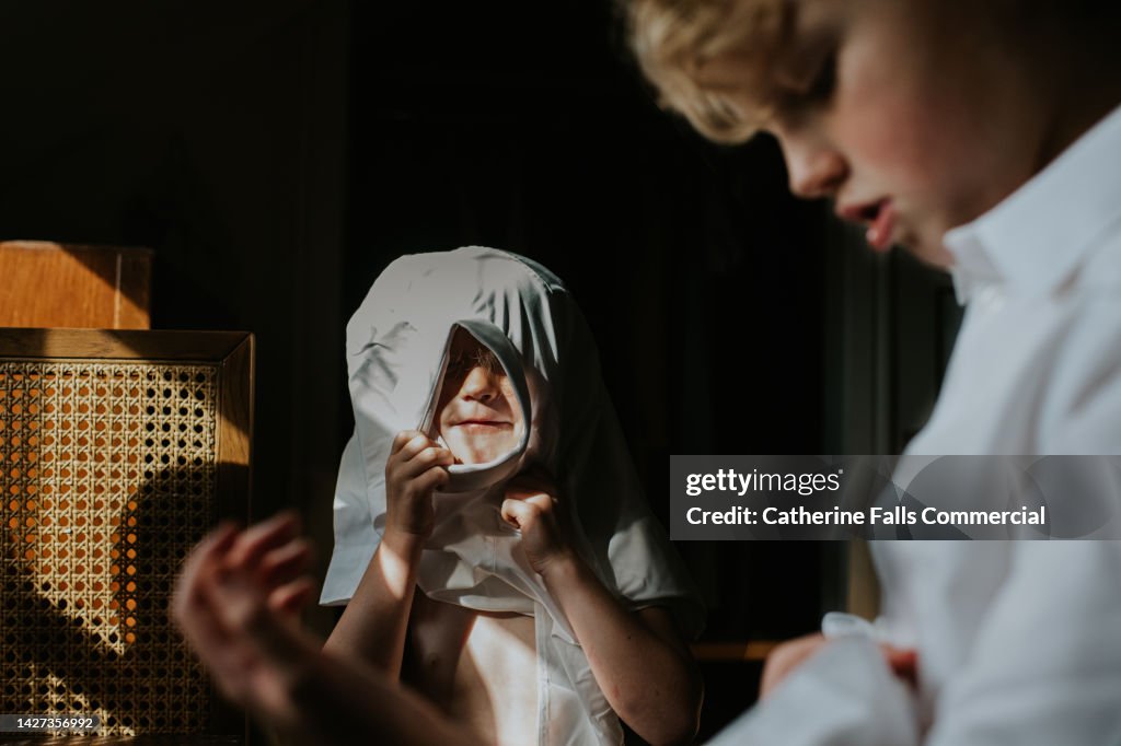 Relatable image of a child attempting to dress herself before school, getting stuck in the fresh white shirt as she does so