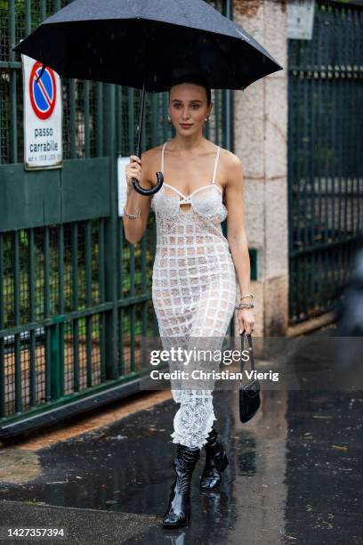 Mary Leest wears white see trough dress, black boots, Prada bag outside Ermanno Scervino during the Milan Fashion Week - Womenswear Spring/Summer...