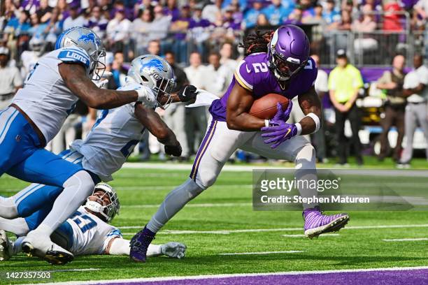 Alexander Mattison of the Minnesota Vikings runs with the ball for a touchdown against the Detroit Lions during the fourth quarter at U.S. Bank...