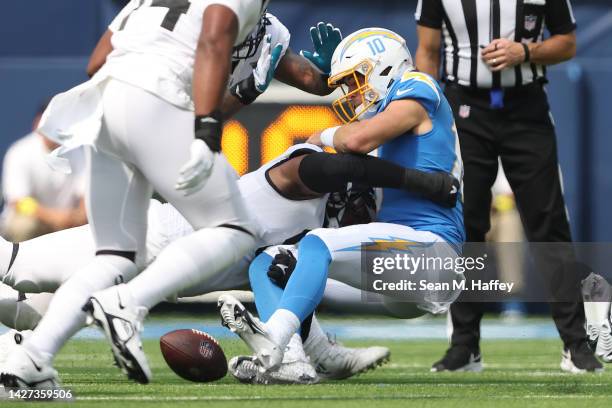 Justin Herbert of the Los Angeles Chargers fumbles the ball while being sacked by Dawuane Smoot of the Jacksonville Jaguars during the second quarter...