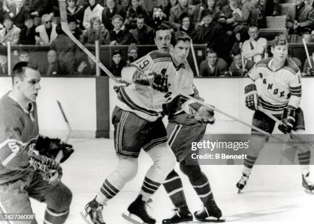 Jean Beliveau of the Montreal Canadiens tries to tie up Jean Ratelle of the New York Rangers as Gilles Tremblay of the Canadiens and Vic Hadfield of...