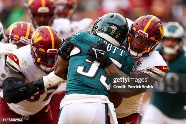 Defensive tackle Daron Payne of the Washington Commanders tackles running back Boston Scott of the Philadelphia Eagles for a safety during the fourth...