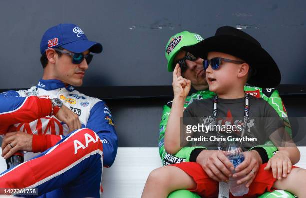 Joey Logano, driver of the AAA Insurance Ford, speaks with Brexton Busch, son of Kyle Busch, driver of the Interstate Batteries Toyota, backstage...