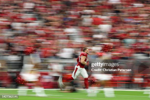 Defensive end J.J. Watt of the Arizona Cardinals runs onto the field before the NFL game against the Los Angeles Rams at State Farm Stadium on...